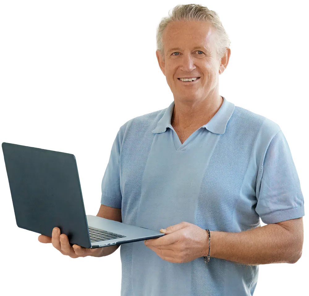 Phil smiling and using laptop