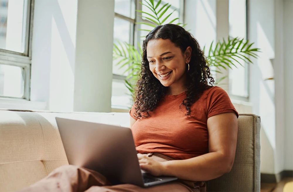 Woman looking at laptop and happy
